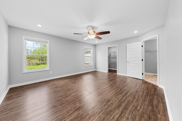 369 Springwater Dr, Summertown, TN 38483 - unfurnished bedroom featuring multiple windows, dark wood-style floors, a spacious closet, recessed lighting, and ceiling fan