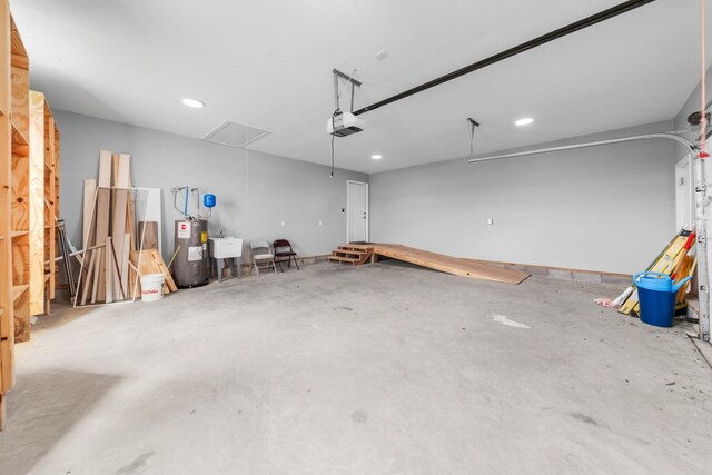 369 Springwater Dr, Summertown, TN 38483 - garage with water heater, a garage door opener, and recessed lighting