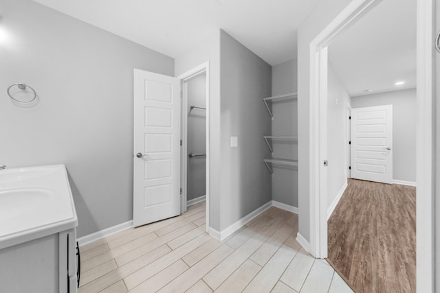 369 Springwater Dr, Summertown, TN 38483 - full bathroom featuring wood finished floors, double vanity, and a spacious closet