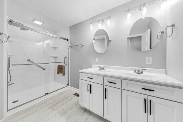 369 Springwater Dr, Summertown, TN 38483 - bathroom featuring double vanity, a shower stall, and wood finished floors