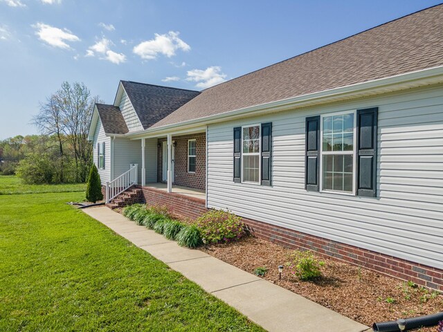 369 Springwater Dr, Summertown, TN 38483 - view of side of home featuring a porch, a yard, and a shingled roof
