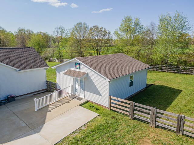 369 Springwater Dr, Summertown, TN 38483 - view of front of property with a fenced backyard, roof with shingles, a patio area, and an outdoor structure