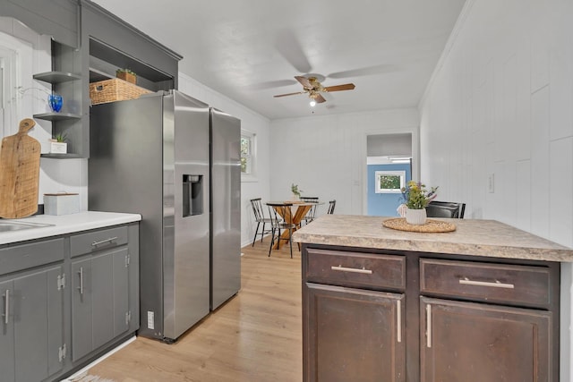 1827 Shelley St, Murfreesboro, TN 37129 - kitchen with stainless steel fridge, ceiling fan, open shelves, light wood-style flooring, and light countertops
