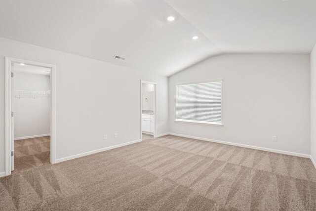 2049 Lala Loop, White Bluff, TN 37187 - unfurnished bedroom featuring light carpet, a spacious closet, lofted ceiling, recessed lighting, and a closet