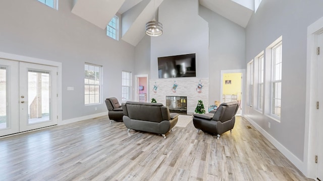 3310 Rocky Branch Rd, Watertown, TN 37184 - living area with high vaulted ceiling, french doors, a glass covered fireplace, and wood finished floors