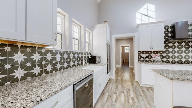 3310 Rocky Branch Rd, Watertown, TN 37184 - kitchen featuring stainless steel dishwasher, exhaust hood, backsplash, white cabinets, and light stone countertops