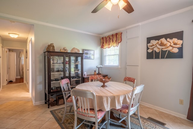 502 Budd St, Saint Joseph, TN 38481 - dining area with light tile patterned floors, ornamental molding, and a ceiling fan