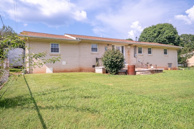 502 Budd St, Saint Joseph, TN 38481 - rear view of house featuring brick siding and a yard