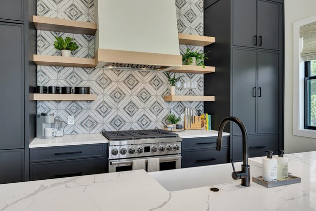 7025 Lanceleaf Dr, College Grove, TN 37046 - kitchen featuring open shelves, custom range hood, high end range, backsplash, and light stone countertops