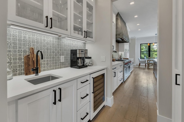 7025 Lanceleaf Dr, College Grove, TN 37046 - kitchen featuring wine cooler, high end stainless steel range, premium range hood, decorative backsplash, and glass insert cabinets