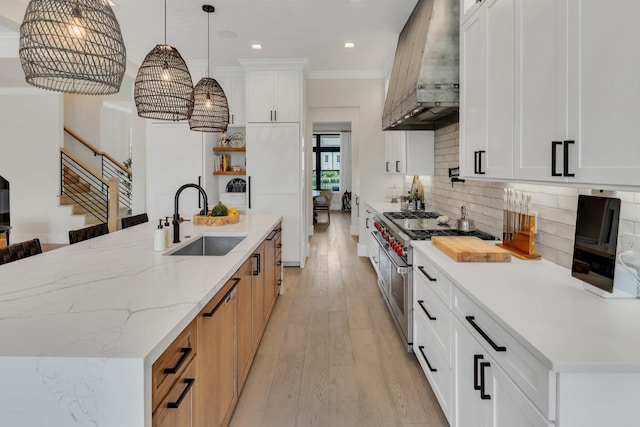 7025 Lanceleaf Dr, College Grove, TN 37046 - kitchen featuring custom exhaust hood, double oven range, light wood-style flooring, a center island with sink, and backsplash