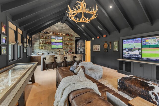 7025 Lanceleaf Dr, College Grove, TN 37046 - home theater room featuring bar with sink, wood finished floors, and a chandelier