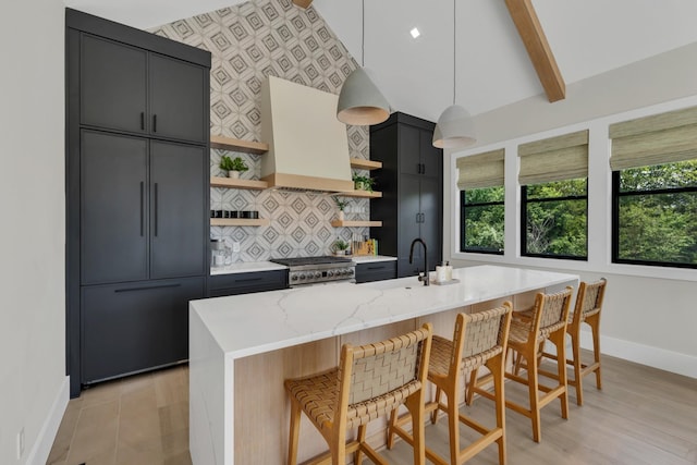 7025 Lanceleaf Dr, College Grove, TN 37046 - kitchen featuring open shelves, premium range hood, a breakfast bar, tasteful backsplash, and beamed ceiling
