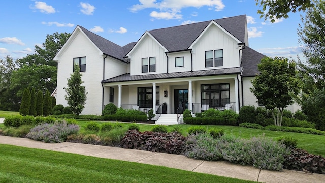 7025 Lanceleaf Dr, College Grove, TN 37046 - modern inspired farmhouse featuring covered porch, a shingled roof, a standing seam roof, a front yard, and board and batten siding