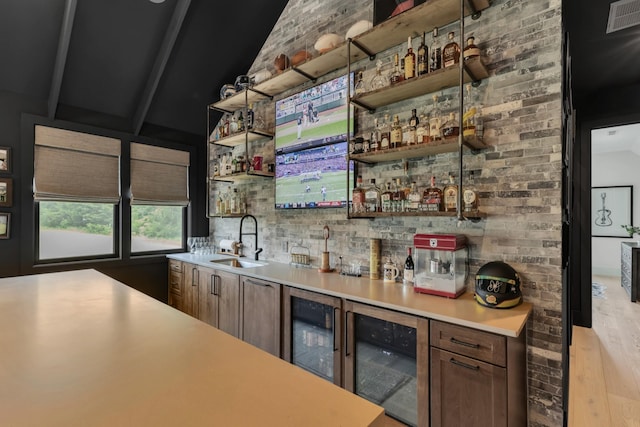 7025 Lanceleaf Dr, College Grove, TN 37046 - indoor wet bar with wine cooler, vaulted ceiling, and wood finished floors