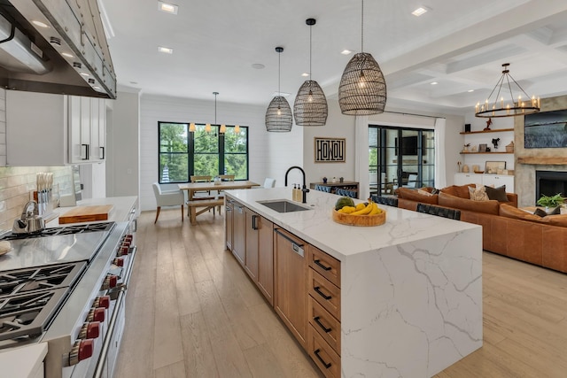 7025 Lanceleaf Dr, College Grove, TN 37046 - kitchen with high end stainless steel range oven, range hood, light wood-style flooring, coffered ceiling, and a chandelier