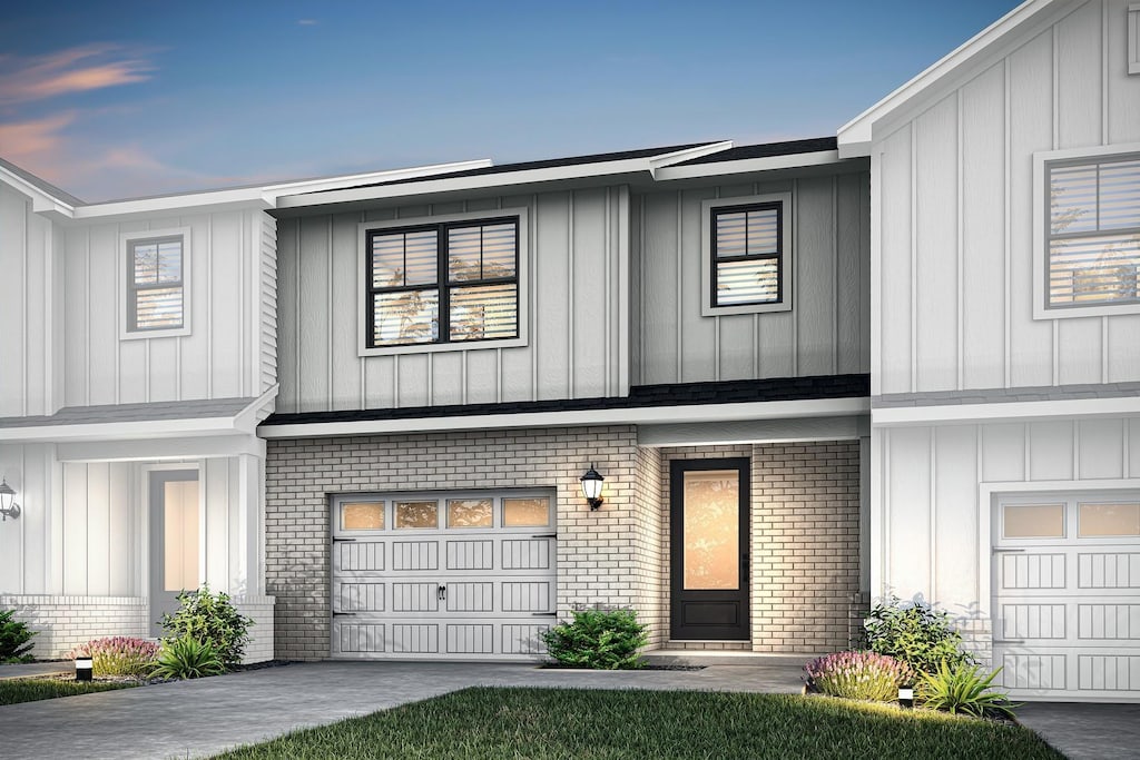 4003 Norman Dr, Spring Hill, TN 37174 - view of property with brick siding, board and batten siding, and a garage
