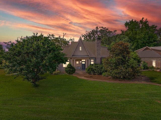 123 Jones Rd, Taft, TN 38488 - view of front facade with a yard, a chimney, and a metal roof
