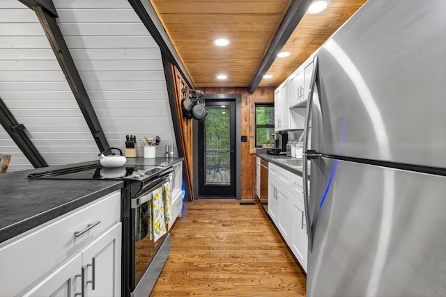 123 Jones Rd, Taft, TN 38488 - kitchen with appliances with stainless steel finishes, recessed lighting, dark countertops, white cabinetry, and light wood-style flooring