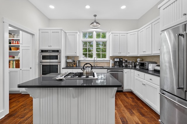 123 Jones Rd, Taft, TN 38488 - kitchen featuring appliances with stainless steel finishes, dark countertops, white cabinetry, recessed lighting, and dark wood-type flooring