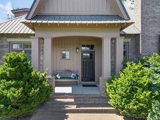 123 Jones Rd, Taft, TN 38488 - entrance to property with a metal roof, board and batten siding, a standing seam roof, covered porch, and brick siding