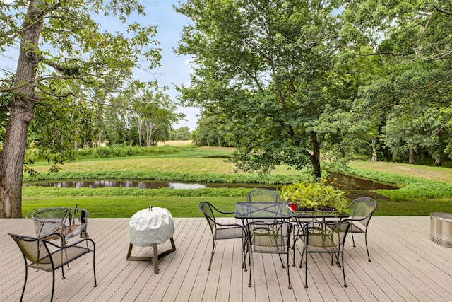 123 Jones Rd, Taft, TN 38488 - deck featuring a water view, a lawn, outdoor dining space, and view of scattered trees