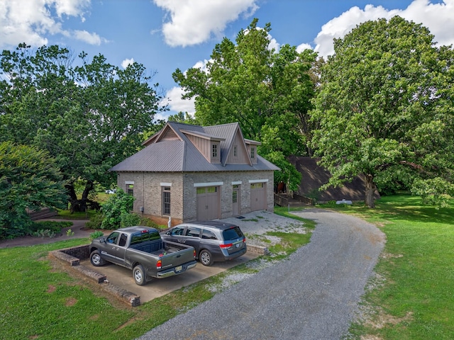 123 Jones Rd, Taft, TN 38488 - view of front of house featuring a front lawn, brick siding, and a metal roof