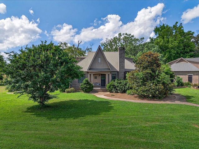 123 Jones Rd, Taft, TN 38488 - craftsman inspired home featuring a chimney, a front lawn, and a metal roof