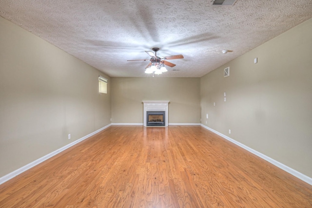 5766 Amalie Dr, Nashville, TN 37211 - unfurnished living room with ceiling fan, a fireplace, light wood-style floors, and a textured ceiling