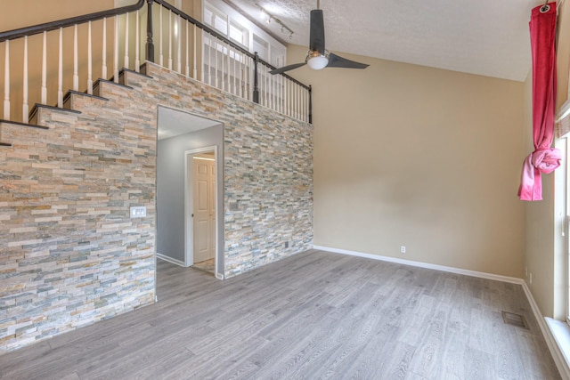 5766 Amalie Dr, Nashville, TN 37211 - empty room featuring a ceiling fan, wood finished floors, a towering ceiling, and plenty of natural light