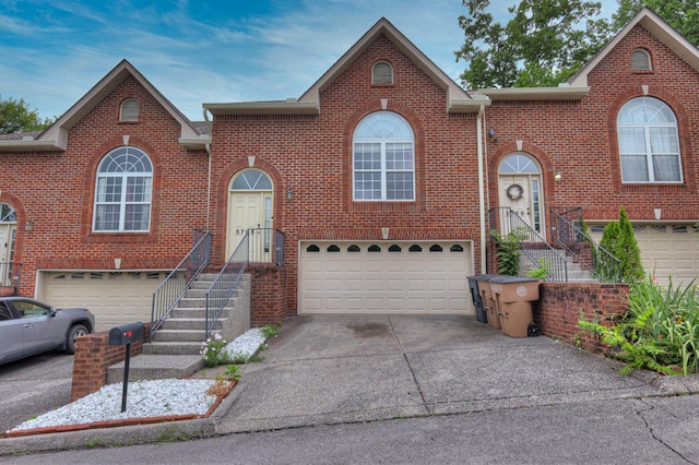 5766 Amalie Dr, Nashville, TN 37211 - view of front facade with an attached garage, brick siding, and driveway