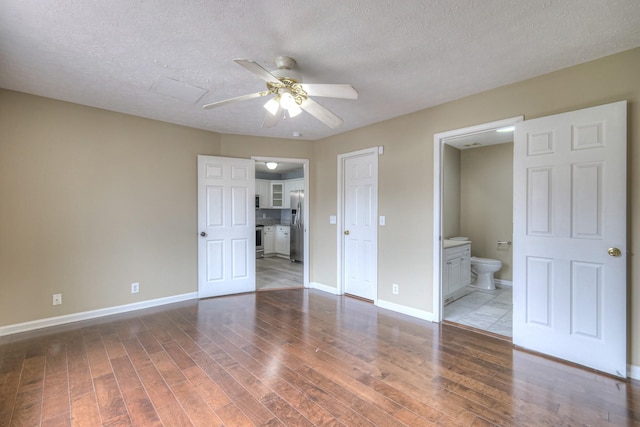 5766 Amalie Dr, Nashville, TN 37211 - unfurnished bedroom featuring stainless steel fridge with ice dispenser, wood finished floors, ensuite bathroom, a textured ceiling, and ceiling fan