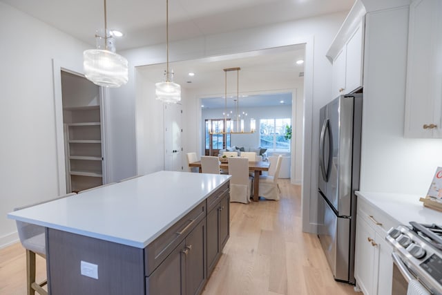 4076 Penfield Dr Unit A, Franklin, TN 37069 - kitchen featuring appliances with stainless steel finishes, light wood-style flooring, a center island, white cabinets, and recessed lighting