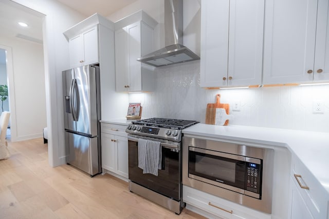 4068 Penfield Dr Unit C, Franklin, TN 37069 - kitchen featuring stainless steel appliances, wall chimney range hood, decorative backsplash, light countertops, and white cabinets
