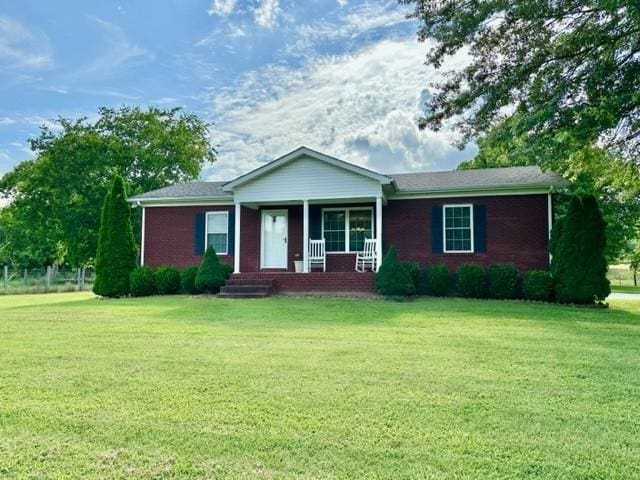 2244 Baptist Branch Rd, Mount Pleasant, TN 38474 - ranch-style house featuring a porch, a front lawn, and brick siding