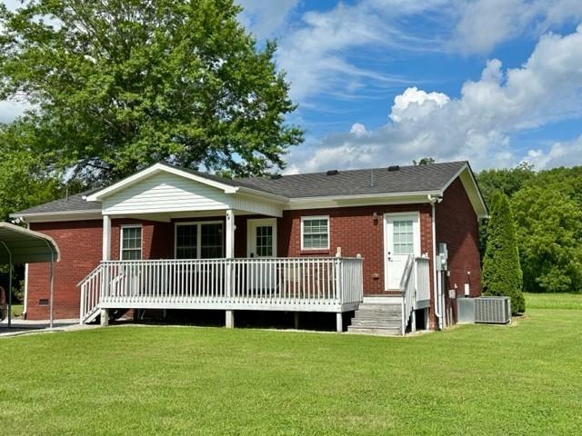 2244 Baptist Branch Rd, Mount Pleasant, TN 38474 - rear view of property featuring brick siding, a detached carport, a yard, and covered porch