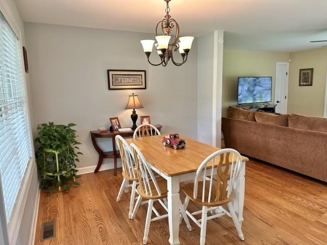 2244 Baptist Branch Rd, Mount Pleasant, TN 38474 - dining space featuring plenty of natural light, light wood-style floors, and a chandelier