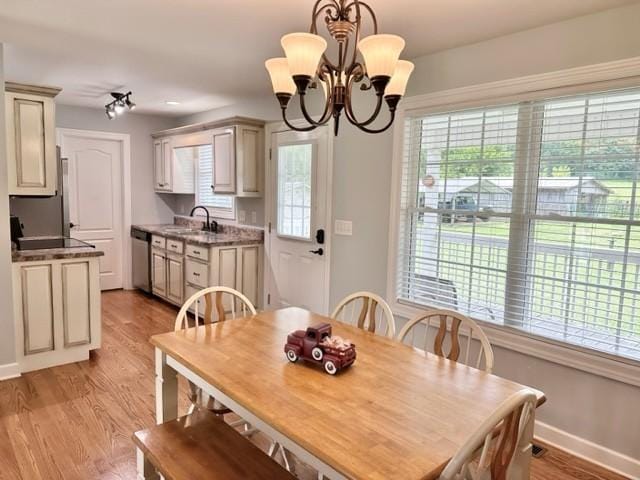 2244 Baptist Branch Rd, Mount Pleasant, TN 38474 - dining space with light wood-style floors and a chandelier
