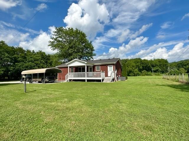 2244 Baptist Branch Rd, Mount Pleasant, TN 38474 - back of property featuring a lawn, a deck, and a detached carport