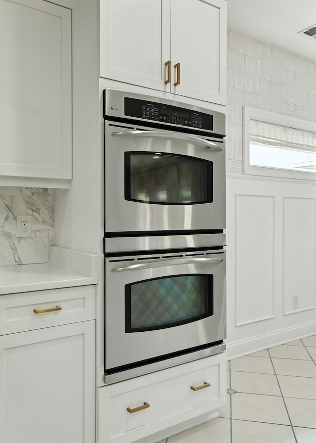 2976 Kingston Cir S, Mount Juliet, TN 37122 - kitchen with double oven, light tile patterned flooring, light countertops, and white cabinets