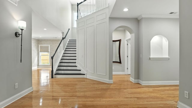 2976 Kingston Cir S, Mount Juliet, TN 37122 - entrance foyer featuring stairs, light wood-type flooring, crown molding, arched walkways, and recessed lighting