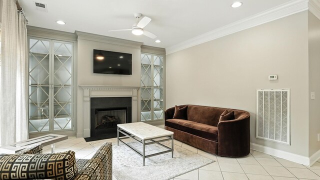 2976 Kingston Cir S, Mount Juliet, TN 37122 - living room with ceiling fan, light tile patterned floors, ornamental molding, a heating unit, and a fireplace with flush hearth