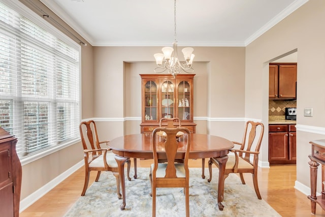 5019 John Hagar Rd, Hermitage, TN 37076 - dining room featuring light wood-style floors, a chandelier, and crown molding