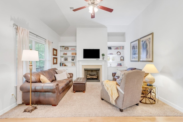 5019 John Hagar Rd, Hermitage, TN 37076 - living area featuring built in shelves, a ceiling fan, a fireplace, and vaulted ceiling