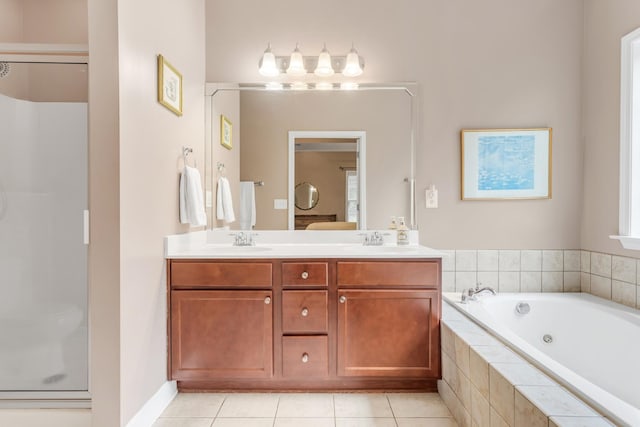 5019 John Hagar Rd, Hermitage, TN 37076 - full bath featuring a jetted tub, double vanity, tile patterned flooring, and a shower