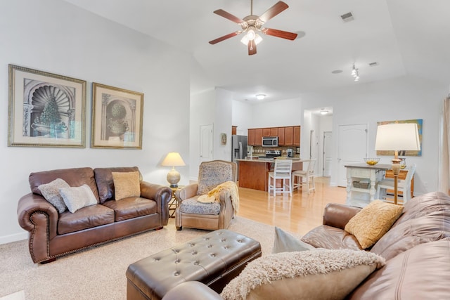 5019 John Hagar Rd, Hermitage, TN 37076 - living room featuring ceiling fan, vaulted ceiling, and light wood-type flooring