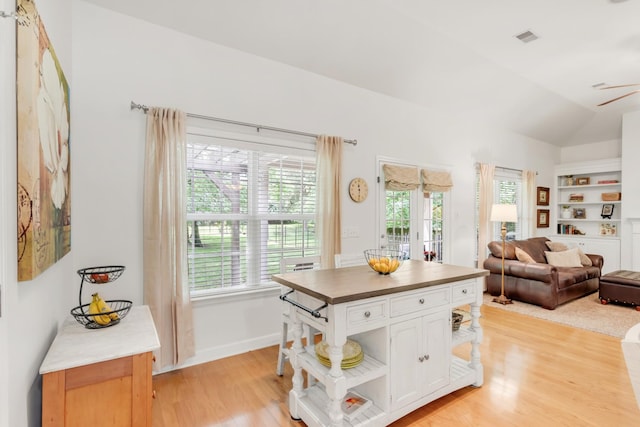 5019 John Hagar Rd, Hermitage, TN 37076 - kitchen with light wood-style floors, white cabinetry, vaulted ceiling, open shelves, and open floor plan
