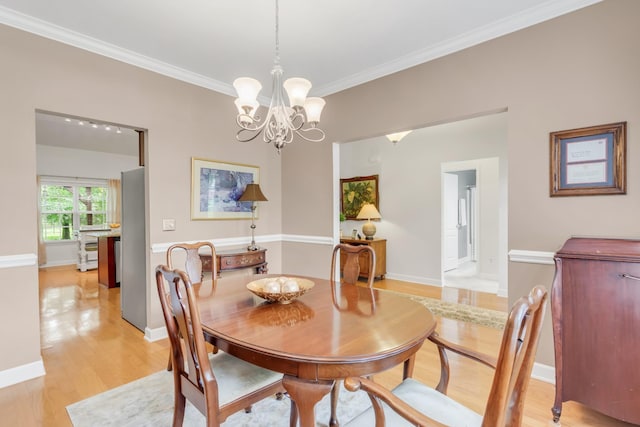 5019 John Hagar Rd, Hermitage, TN 37076 - dining space featuring light wood-style flooring, crown molding, and a chandelier