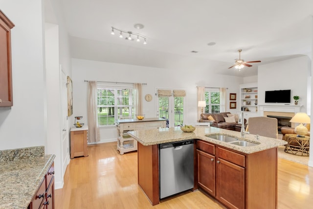 5019 John Hagar Rd, Hermitage, TN 37076 - kitchen featuring stainless steel dishwasher, a fireplace, light wood-style flooring, ceiling fan, and open floor plan