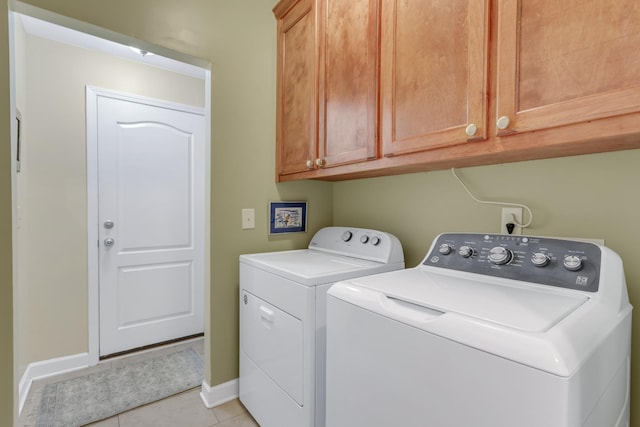 5019 John Hagar Rd, Hermitage, TN 37076 - laundry area featuring washing machine and clothes dryer, cabinet space, and light tile patterned floors